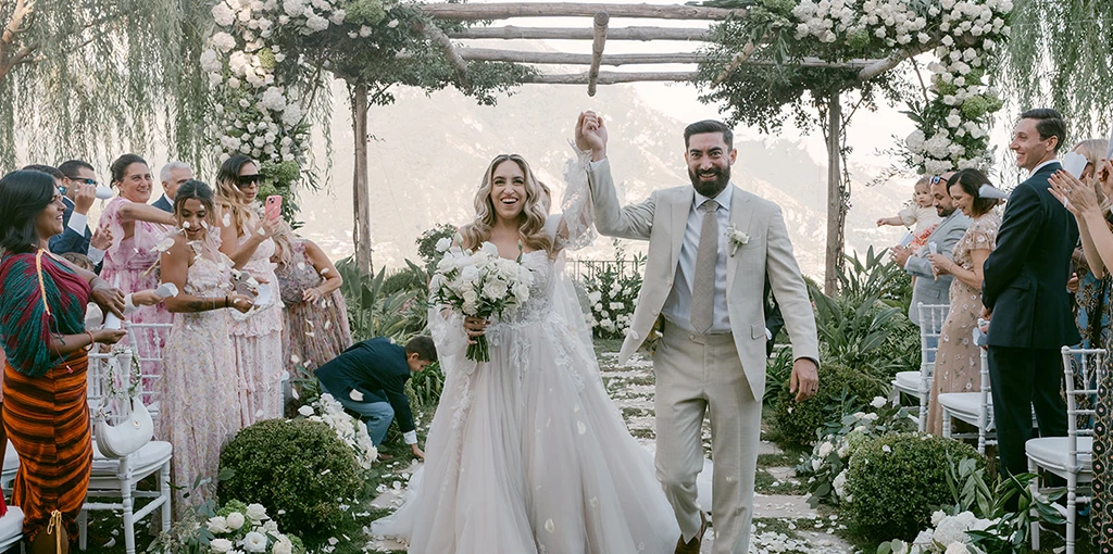 Real Bride Emily and her husband celebrating their wedding ceremony