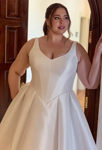 Plus size bride wearing ballgown wedding dress with v-neckline