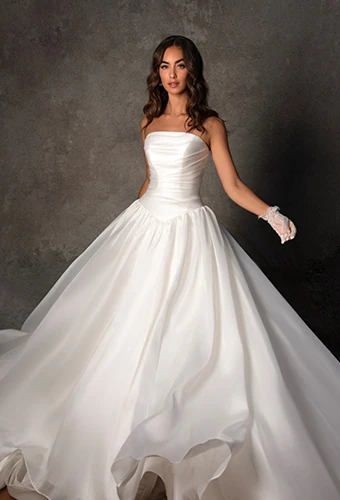 Bride wearing strapless wedding dress withy drop waist
