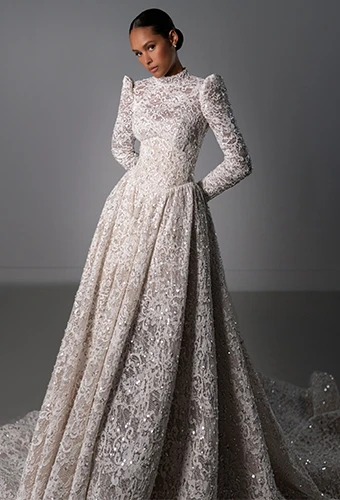 Bride wearing lace ballgown wedding dress with long sleeves and high neckline