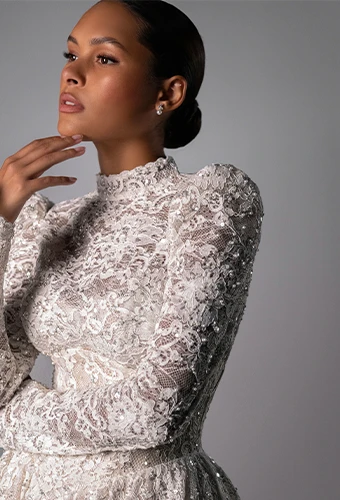 Bride wearing lace long sleeve wedding dress with high neckline