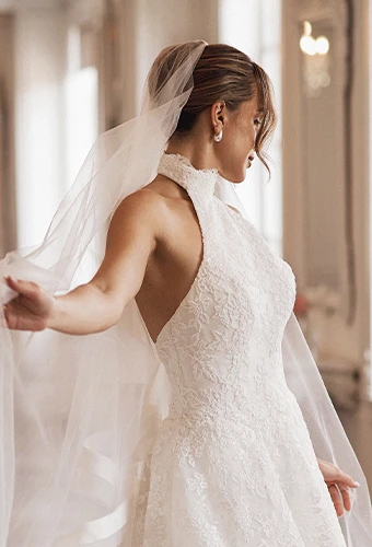 Bride wearing lace wedding dress with halter neckline