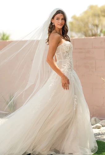 Bride wearing drop waist wedding dress with strapless sweetheart neckline and exposed boning