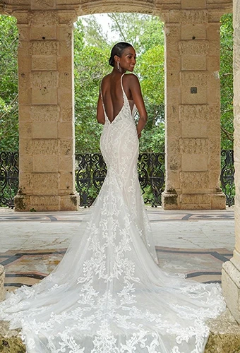 Bride wearing lace fit-and-flare wedding gown with open v-back