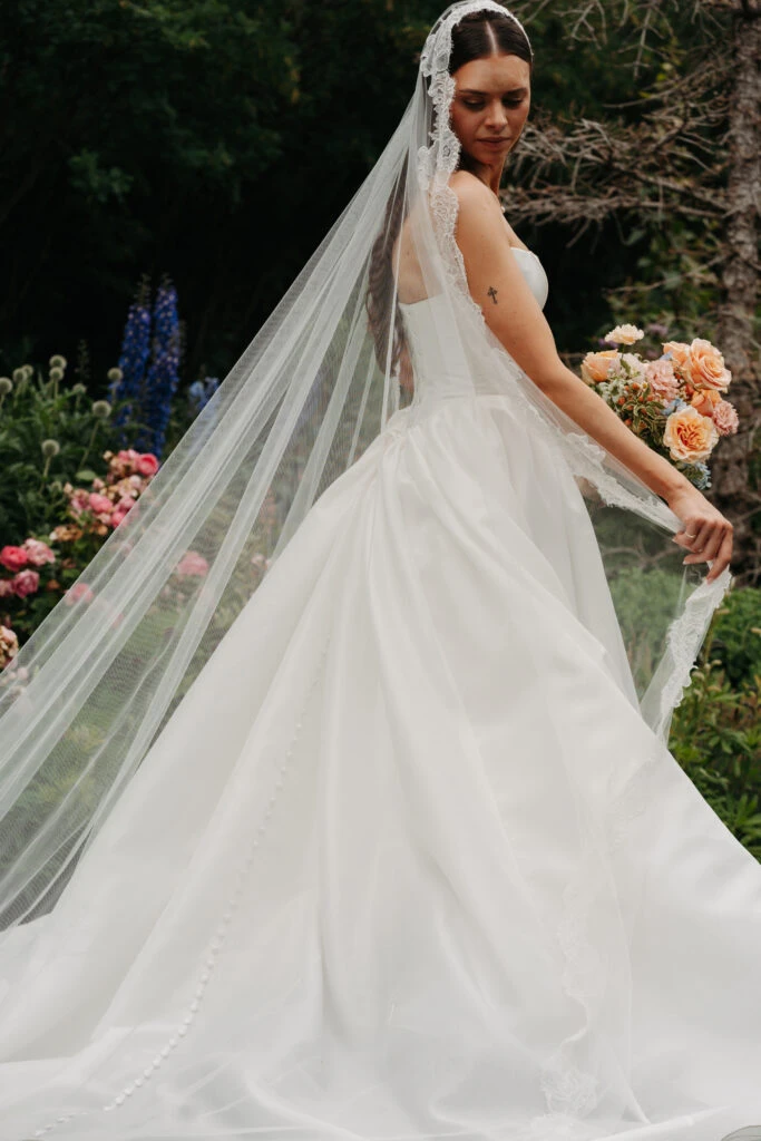 Real bride Gabby posing in her wedding gown