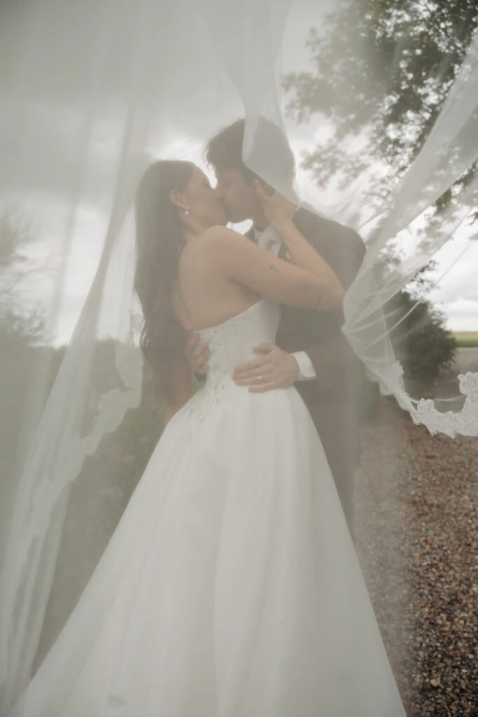 Real bride Gabby embracing her husband