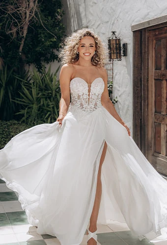 Bride wearing strapless a-line wedding dress with high leg slit and sweetheart neckline 