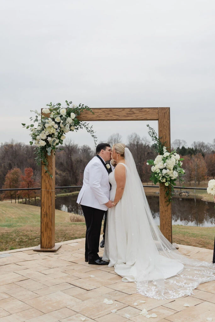 Real bride Alicia embracing her husband at the altar