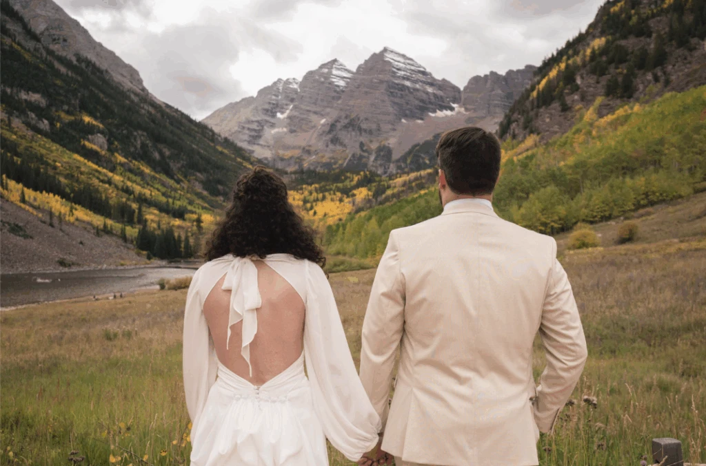 True bride Hayley posing with her husband in front of a mountain landscape