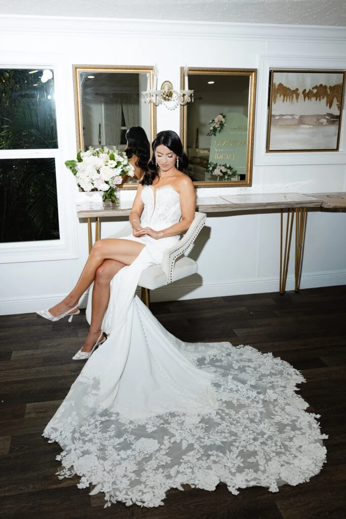 Real bride Jackie posing in her wedding gown while getting ready