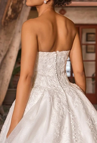 Bride wearing strapless lace ballgown wedding dress with lace details