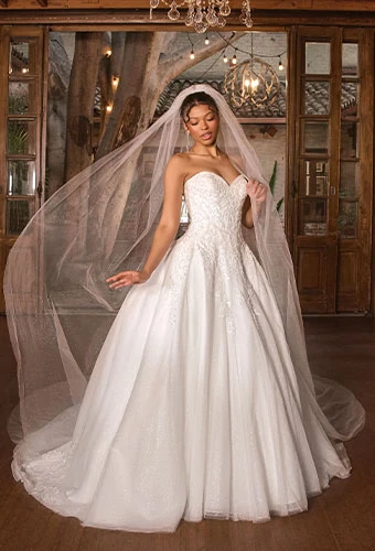 Bride wearing strapless lace ballgown wedding dress with sweetheart neckline and lace details