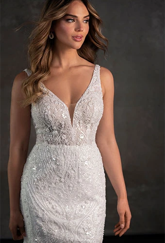 Bride wearing glittering tulle sheath wedding dress with pearl embroidery and v-neckline