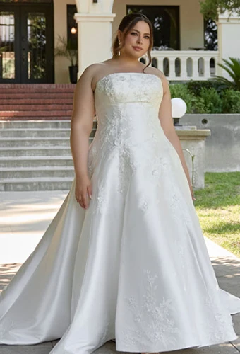 Plus size bride wearing strapless satin wedding dress with lace appliques