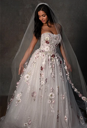 Bride wearing sparking tulle ballgown wedding dress with colorful floral lace and strapless scoop neckline