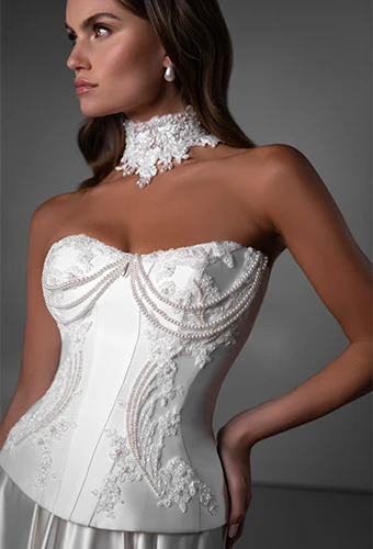 Bride wearing strapless two piece wedding dress with draped beading and lace details