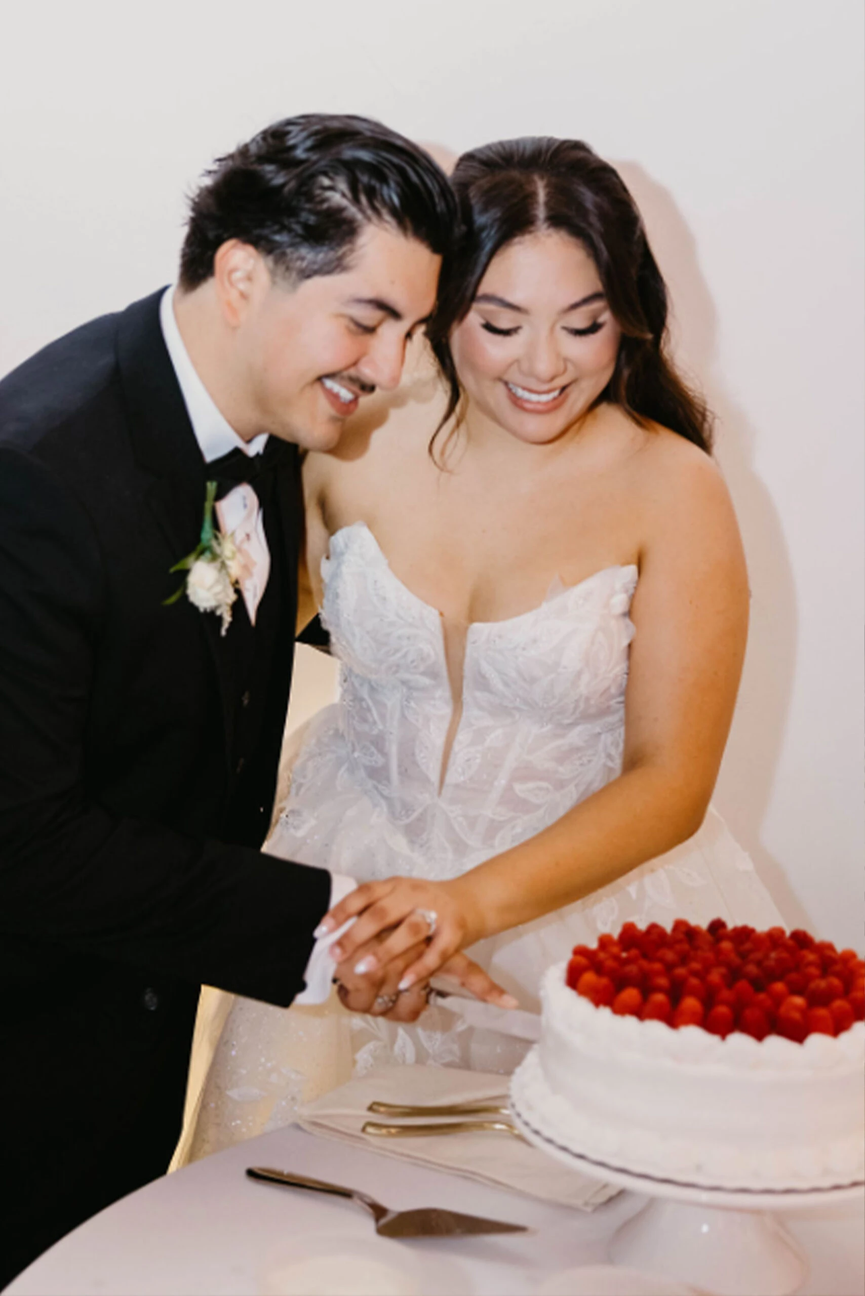 Real bride Maria cutting the cake with her husband