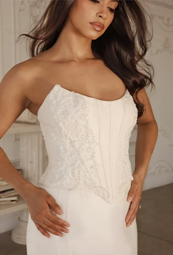 Bride wearing strapless satin wedding dress with scoop neckline and beaded lace details