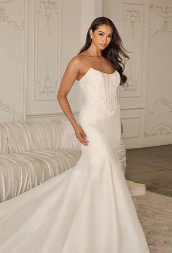 Bride wearing strapless satin wedding dress with scoop neckline and beaded lace details