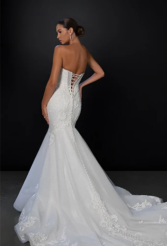 Bride wearing strapless fit and flare wedding dress with lace up back