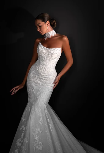 Bride wearing strapless fit and flare wedding dress with beading and lace appliques