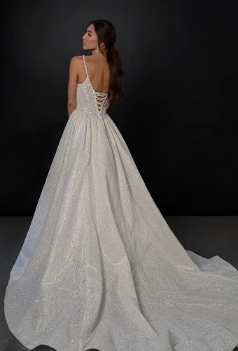 Bride wearing sparkling tulle wedding dress with thin straps