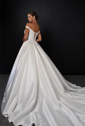 Bride wearing off the shoulder ballgown wedding dress with lace up back