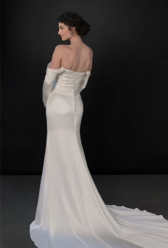 Bride wearing long sleeved off the shoulder wedding dress with sweetheart neckline