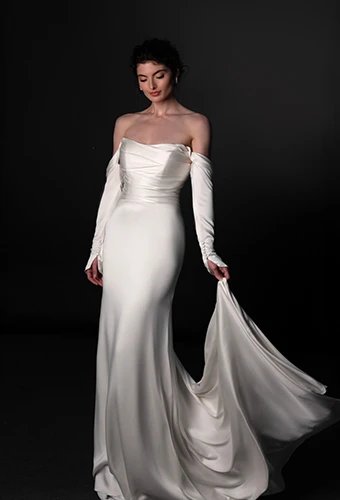 Bride wearing long sleeved off the shoulder wedding dress with sweetheart neckline