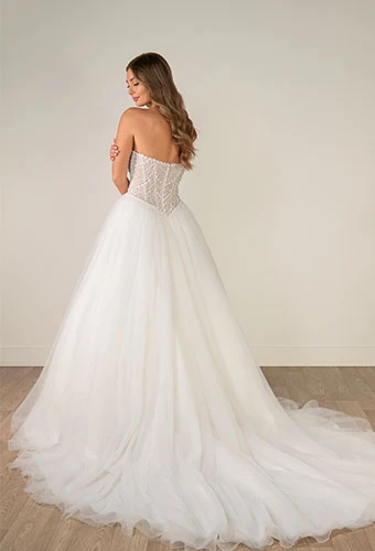 Bride wearing strapless ballgown wedding dress with pearl-beaded corset
