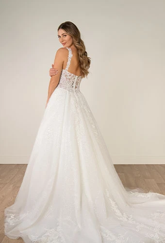 Bride wearing sparkling a-line wedding dress with v-neckline and shoulder straps