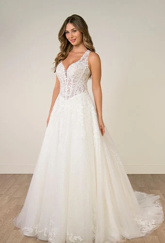 Bride wearing sparkling a-line wedding dress with v-neckline and shoulder straps