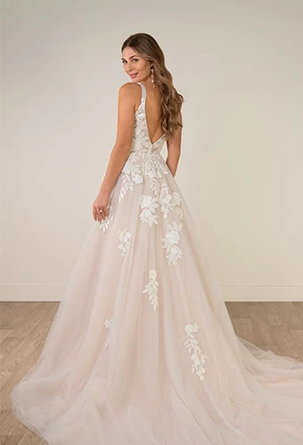 Bride wearing lace wedding dress with open v-back and shoulder straps