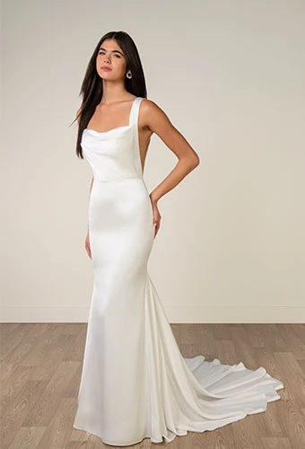 Bride wearing minimalist satin wedding dress with cowl neckline and shoulder straps