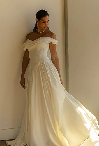 Bride wearing a-line wedding dress with sweetheart neckline and off-the-shoulder wedding dress