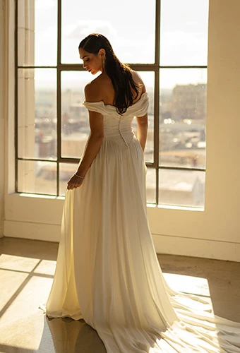 Bride wearing a-line wedding dress with sweetheart neckline and off-the-shoulder wedding dress