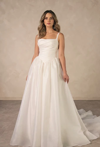 Bride wearing square neck a-line wedding dress with draped bodice and thin shoulder straps