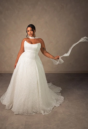 Plus size bride wearing strapless a-line wedding gown with allover lace and sweetheart neckline
