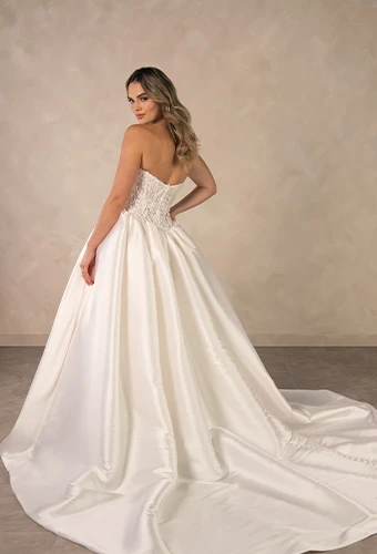 Bride wearing strapless ballgown wedding dress with beaded lace corset