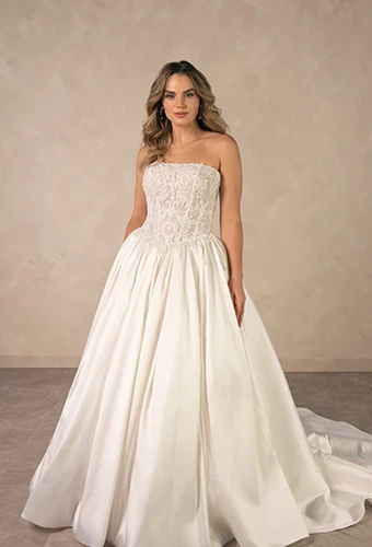 Bride wearing strapless ballgown wedding dress with beaded lace corset