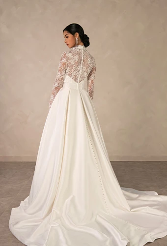 Bride wearing ballgown wedding dress with sweetheart neckline and detachable lace jacket
