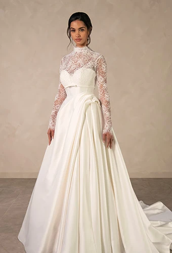 Bride wearing ballgown wedding dress with sweetheart neckline and detachable lace jacket