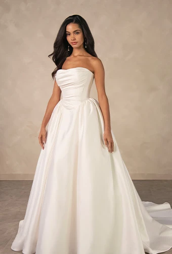 Bride wearing minimalist strapless ballgown wedding dress with a basque waist