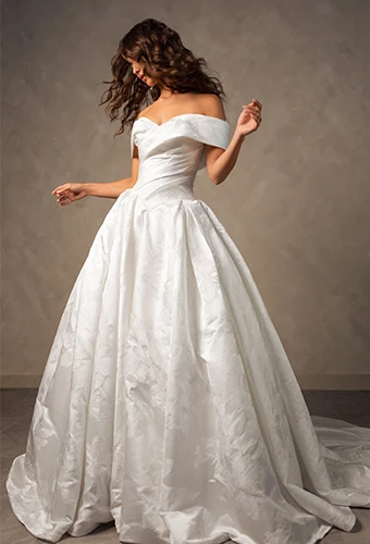 Bride wearing jacquard ballgown wedding dress with off-the-shoulder straps