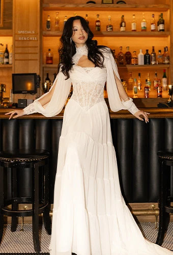 Bride wearing a-line wedding dress with lace bodice and faux high neckline