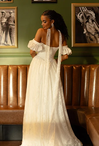 Bride wearing simple a-line wedding dress with off-the-shoulder straps