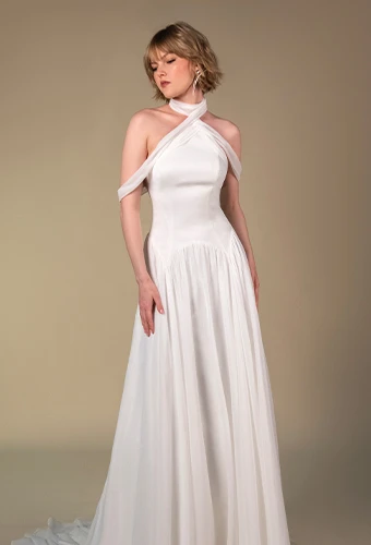 Bride wearing chiffon a-line wedding dress with asymmetrical neckline
