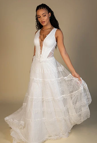 Bride wearing lace a-line wedding dress with plunging v-neckline and side cutouts