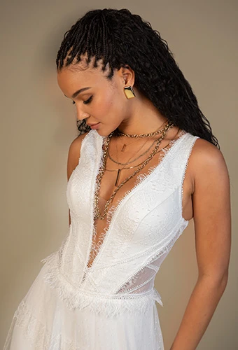 Bride wearing lace a-line wedding dress with plunging v-neckline and side cutouts