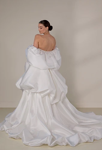 Bride wearing sparkling lace and mikado wedding dress with dramatic bubble overskirt